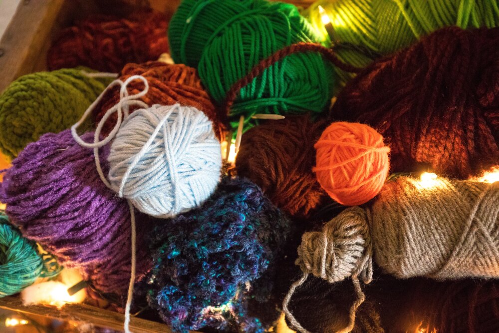 Photo of colourful balls of yarn by  Jason Leung  on  Unsplash