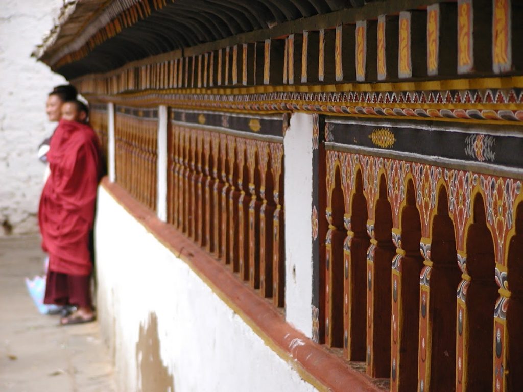 Temple in Bhutan with three monks in the background