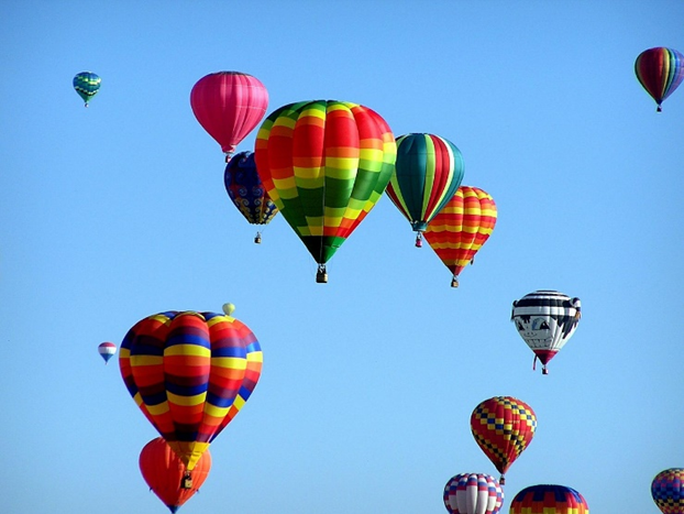 photo of hot air balloons in flight against a clear blue sky