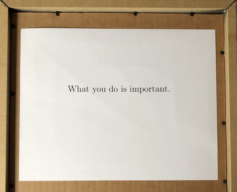The back of a picture frame.  In type is reads, "What you do is important."
